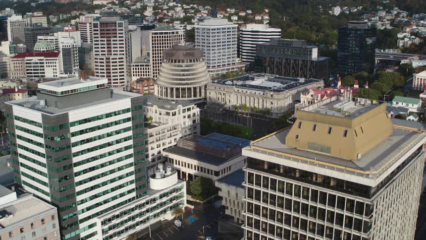 Cars travel on the city streets and highways near the city buildings