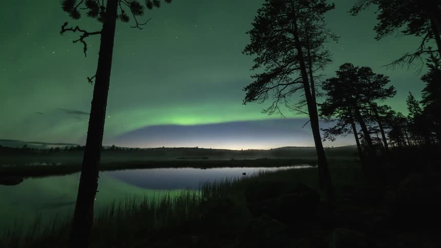 The northern lights arc across the sky