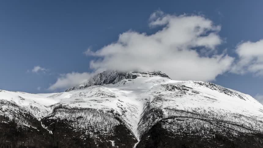 Time lapse of clouds moving over a mountain top