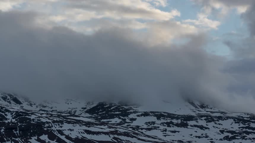 Clouds and mists form and move over mountains in timelapse