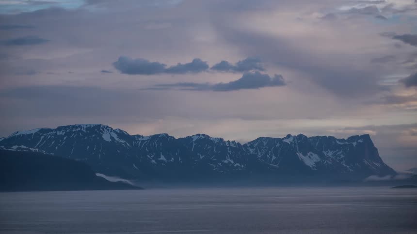 Time lapse of morning clouds over a mountain range