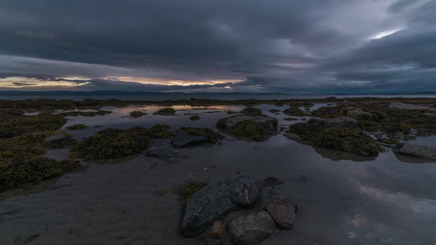 Oceanside time lapse of rolling clouds at sunset