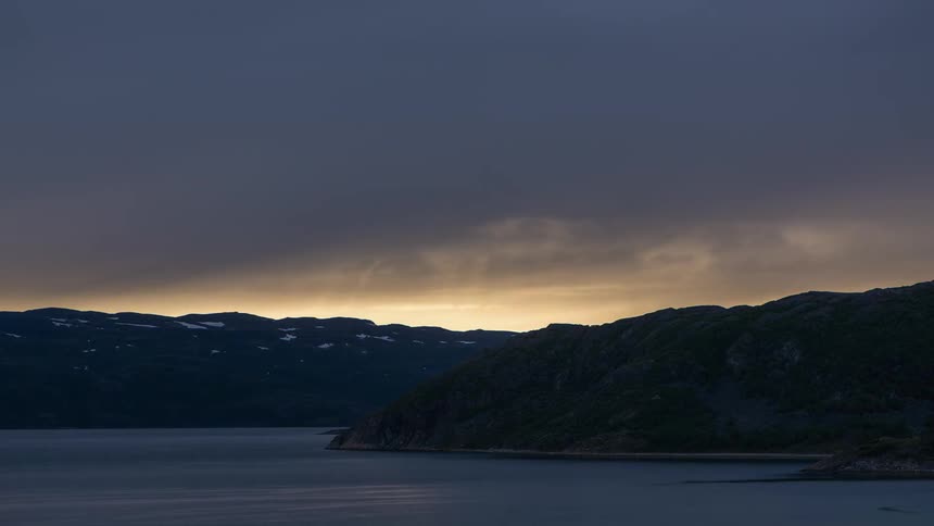 Time-lapse of rain clouds passing over some mountains
