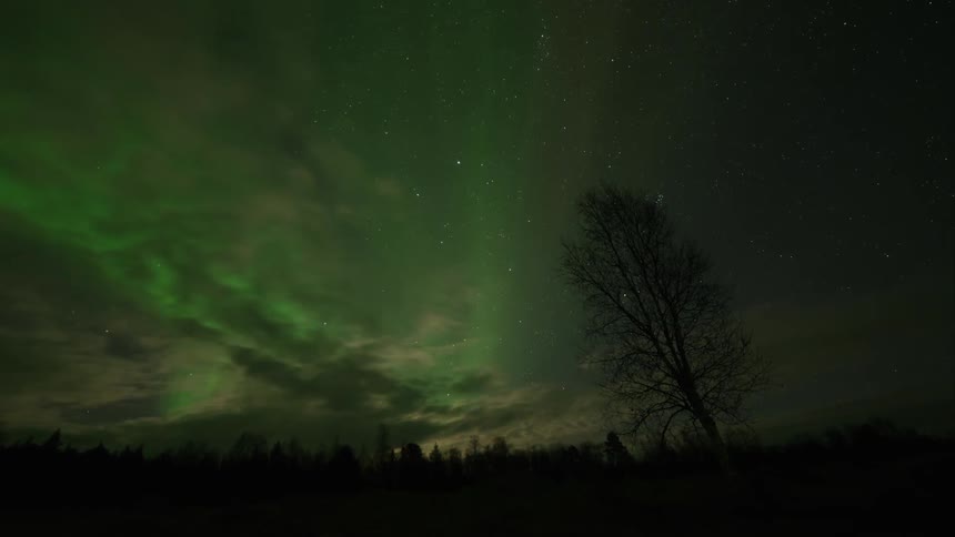Time lapse of green flares above moonlit clouds