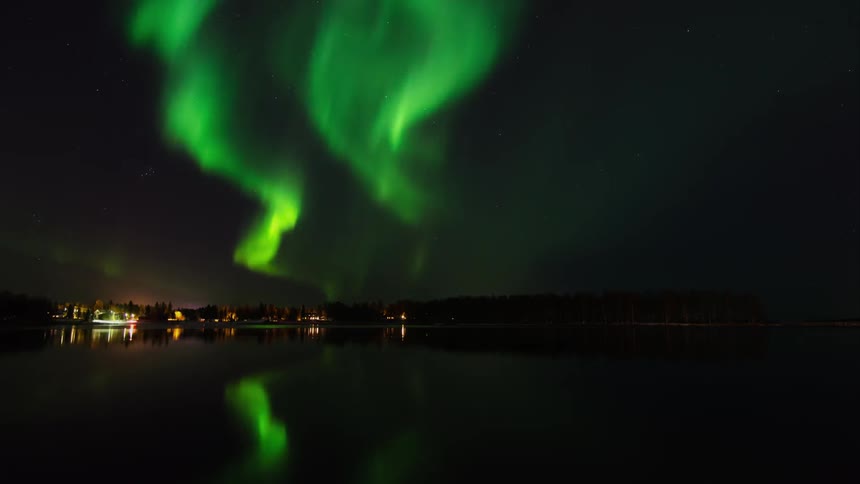 Northern lights mirrored over a body of water