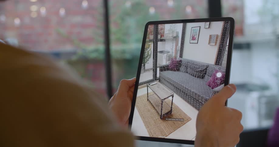 A person is filming the furniture in the living room