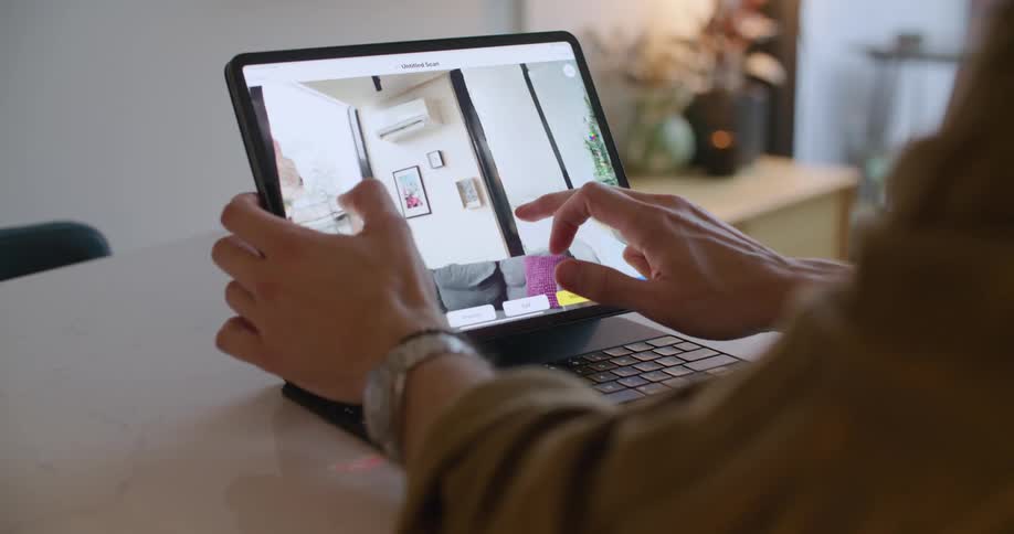 A man inspects a 3D scan on his tablet