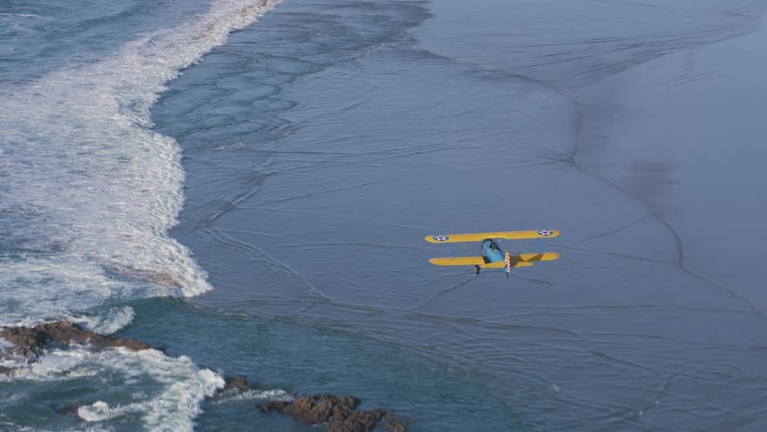 A plane flies over the shore line