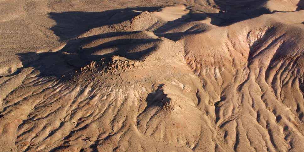 A view of some hills and dunes in the desert