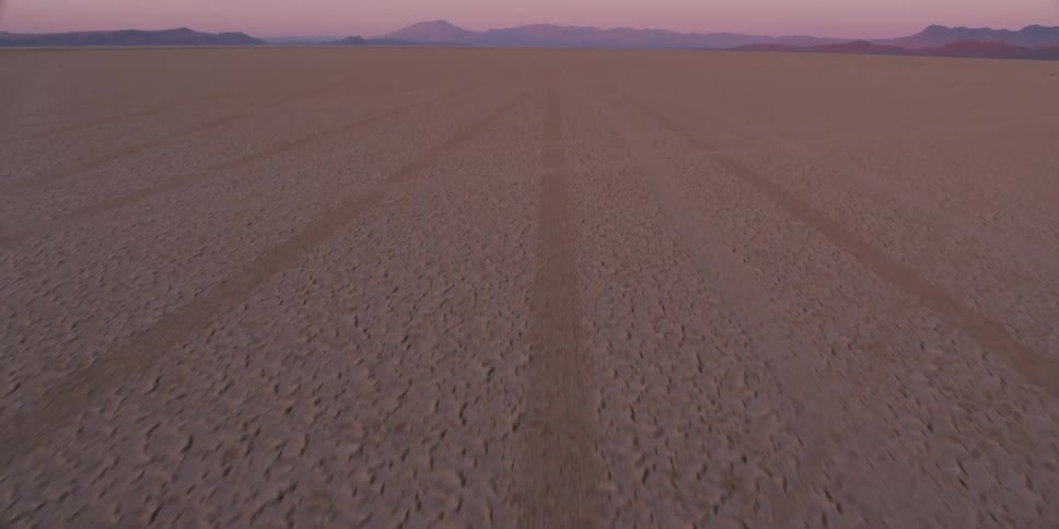 The sun is setting on the desert