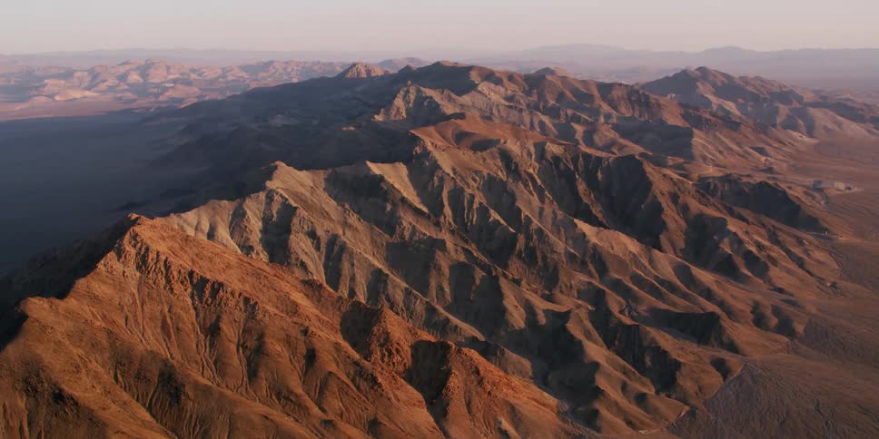 Aerial view of the peaks on a mountain range in the desert at morning