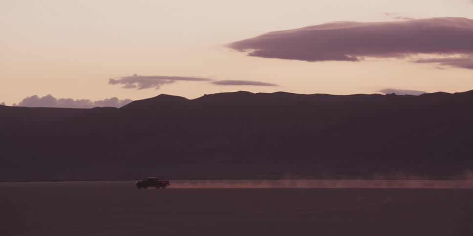 A truck driving down a dirt road