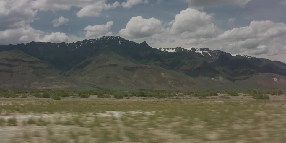 A view of a landscape with mountains in the distance