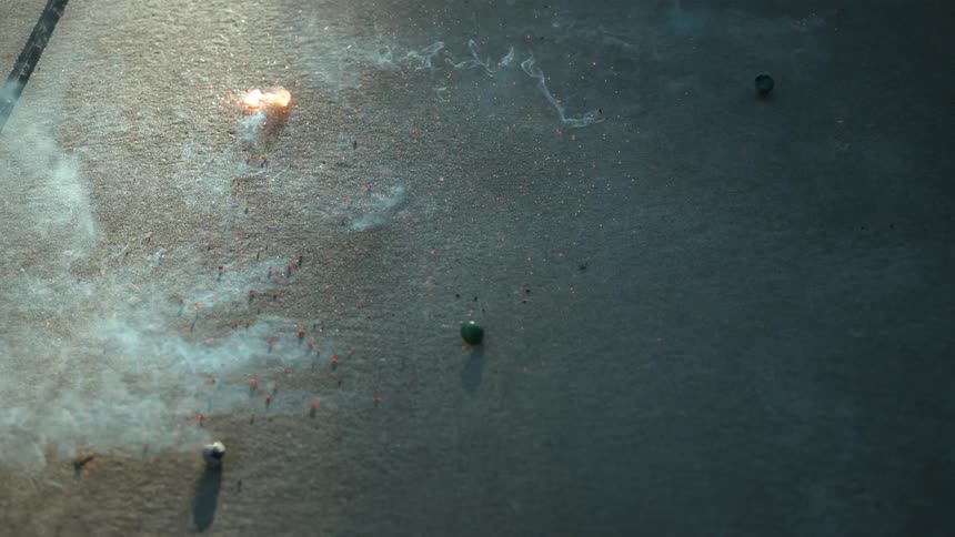 Smoke bombs and flash bangs break apart as they hit the pavement sending sparks flying