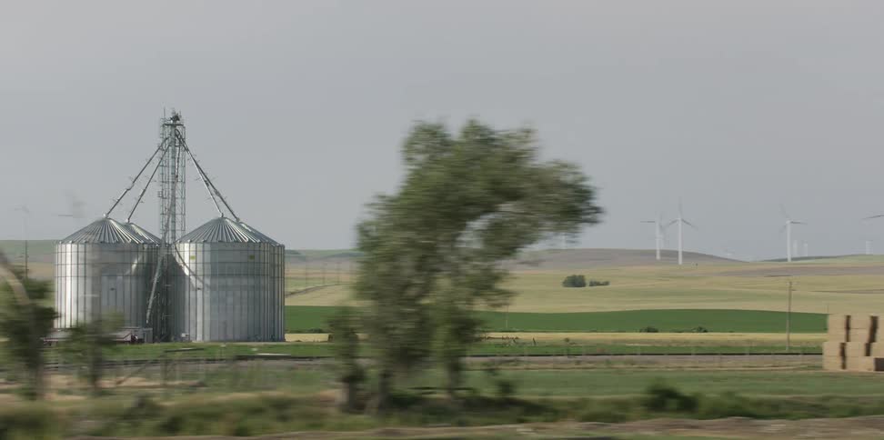 A view of farmland with silos