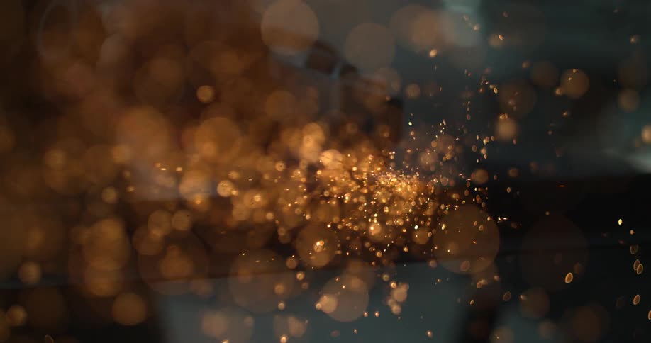 Sparks are flying toward the camera as a person uses a grinding tool while inside