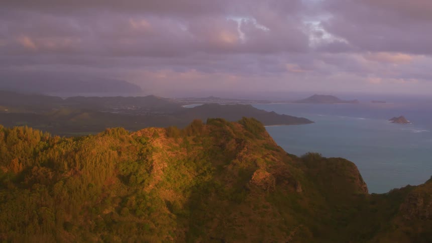 A mountainous ridge stands tall over an ocean coastline