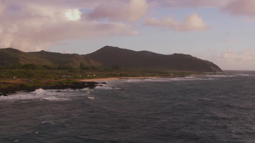 An aerial view of waves crashing against the shore