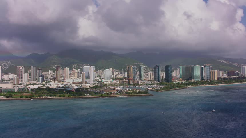 The coastal city is surrounded by blue water
