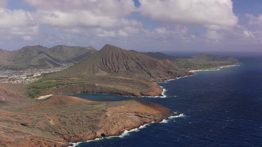 The coast of a landmass containing a bay during the day