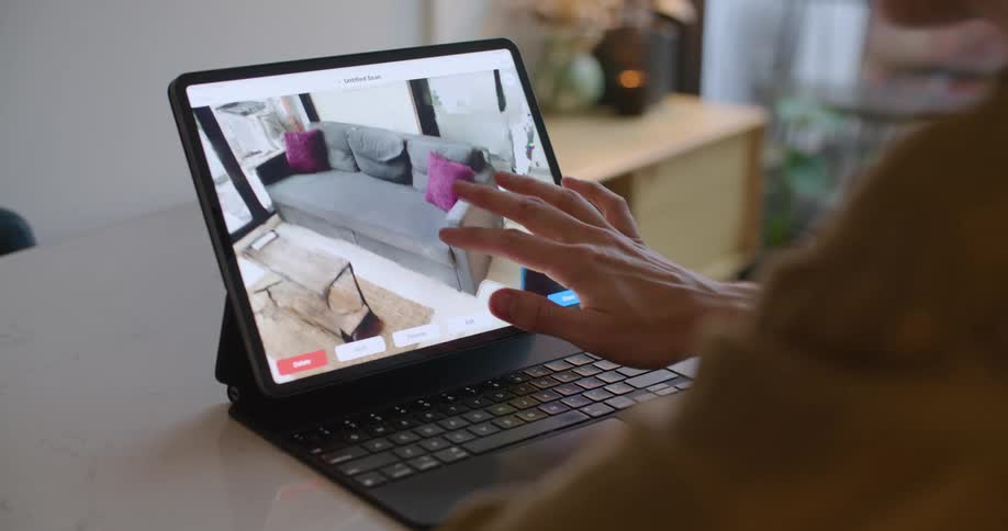 A man inspects a 3D scan on his tablet