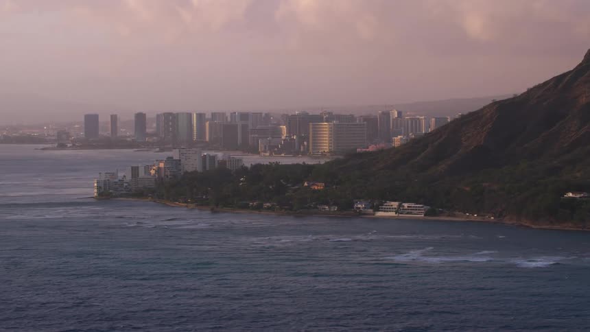 Where the ocean meets the coast line is a large city with many tall buildings