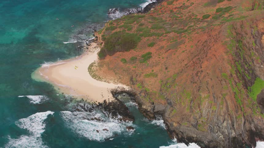 An island surrounded with water and waves