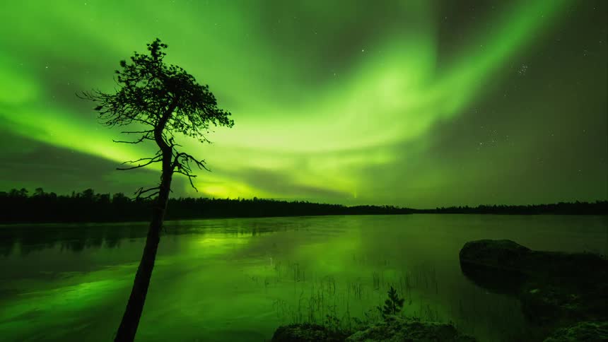 Green flares flashing in a night sky over a frozen lake