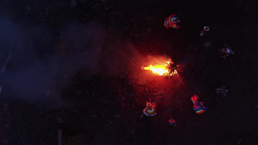 Native americans dancing around a campfire