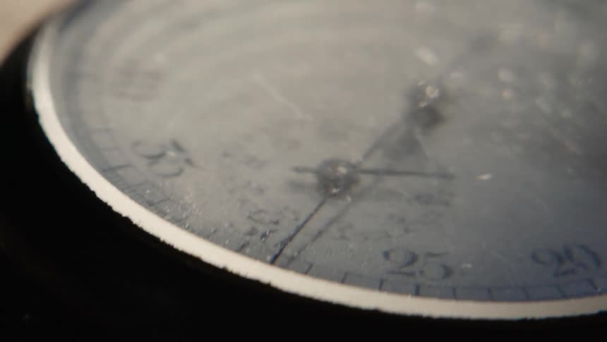 A close view of an analog stopwatch showing the seconds being counted
