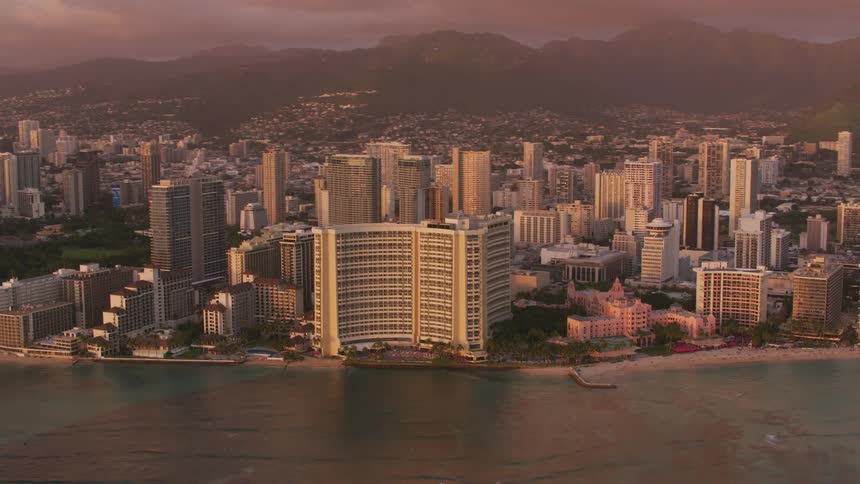 Aerial view of hotels on the beach of a coastal city at sunset
