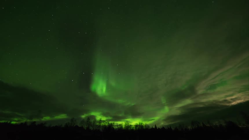 Time lapse of green flares in a cloudy night sky