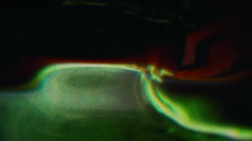 Green orange and black colors that look like water and light
