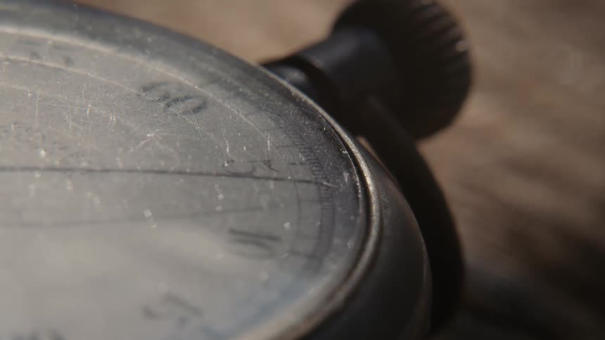 A view of a clock hand moving on a pocket watch