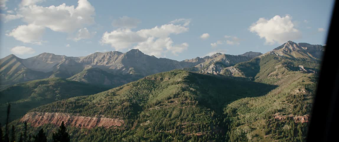 Outside the window is a valley of mountains