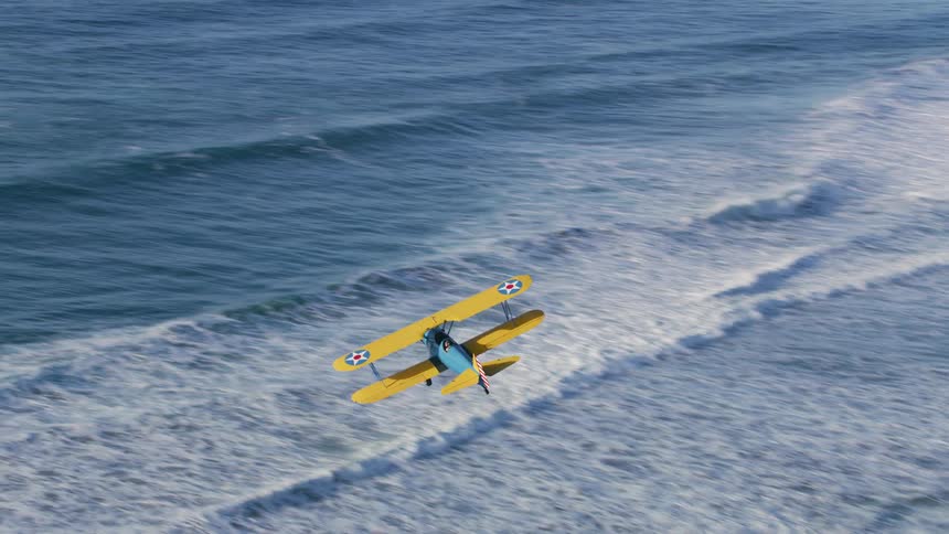 An airplane flying over the ocean with water and waves