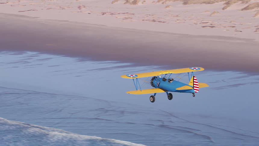 An aerial view of a plane flying over a beach