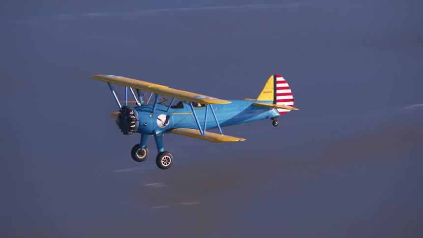 An aerial view of a plane flying over the beach