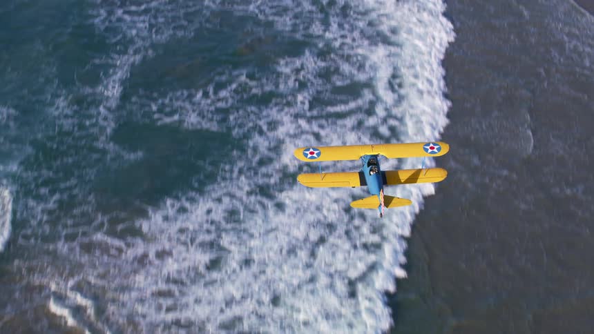 An airplane flying over a coast