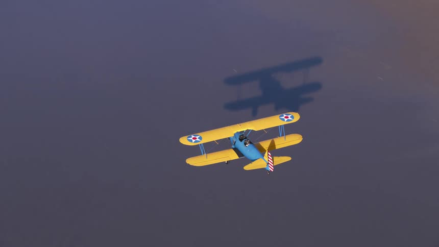 An airplane flying over a beach with water waves and sand