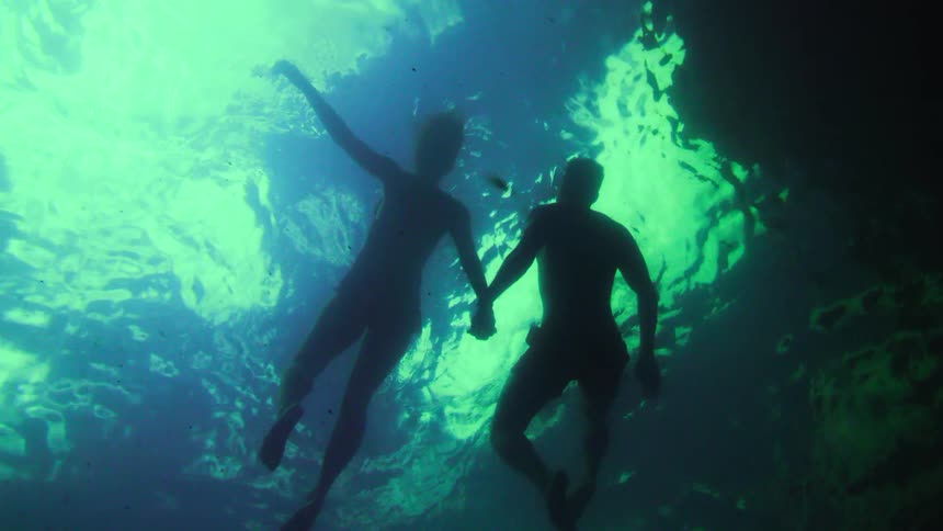 Two people swimming in the ocean