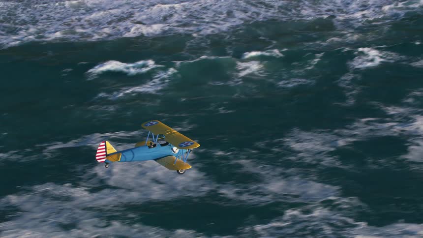 An airplane flying in the air over a beach with waves of water and sand