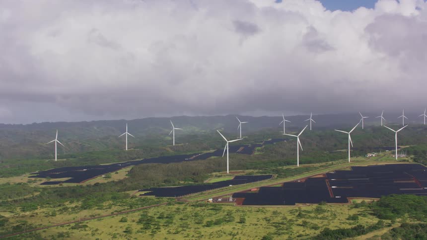 Turbines are spinning on a wind farm on a cloudy day
