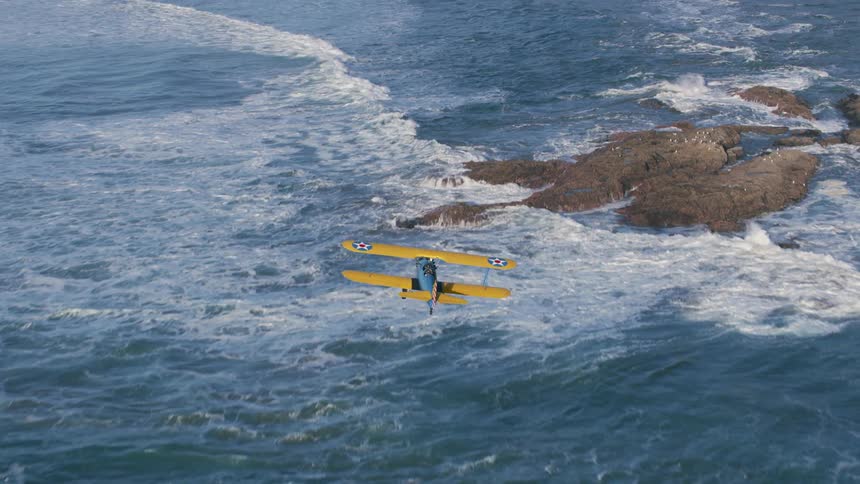An aerial view of a plane flying over the ocean