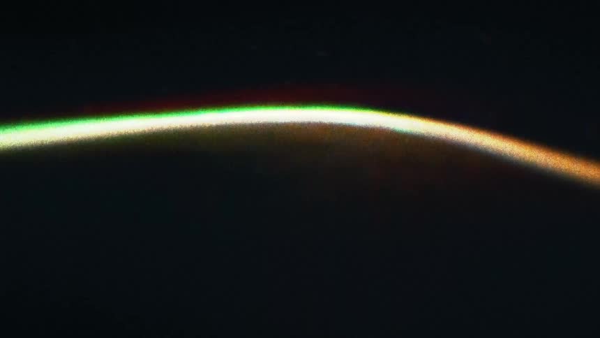 A glowing neon line changes color and moves in waves from left to right