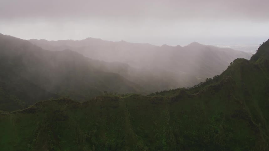 Mountain ridge covered with plants under a hazy sky