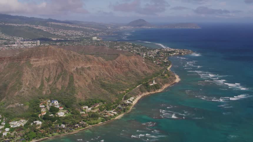 Aerial view of a small coastal town near the mountains next to the ocean