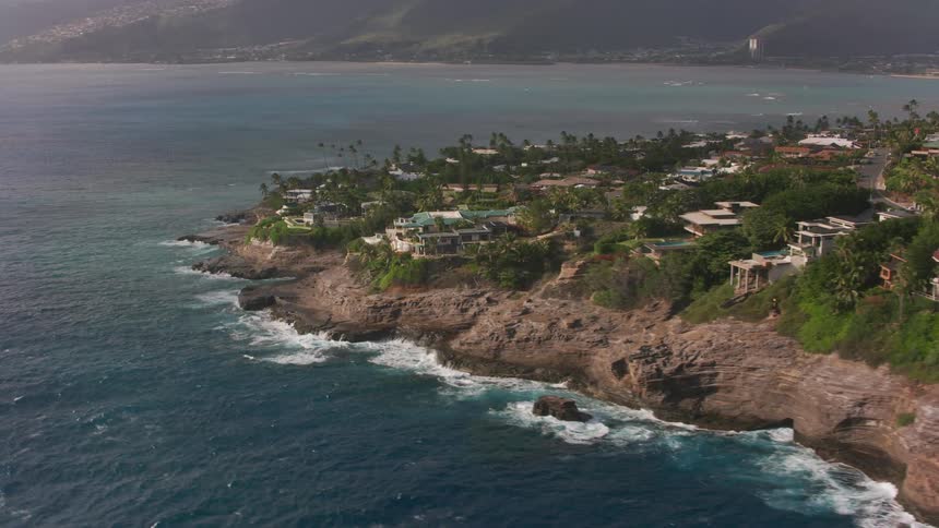 Aerial view of a small coastal town near the mountains close to the ocean