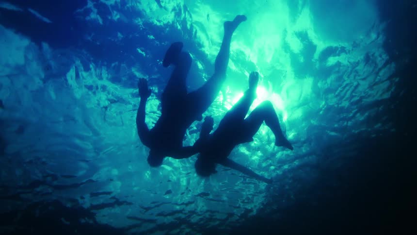 Two people swimming