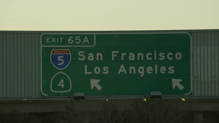 Signs are on the road with traffic